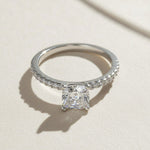 Round-cut lab-grown diamond solitaire engagement ring with pavé band in sterling silver