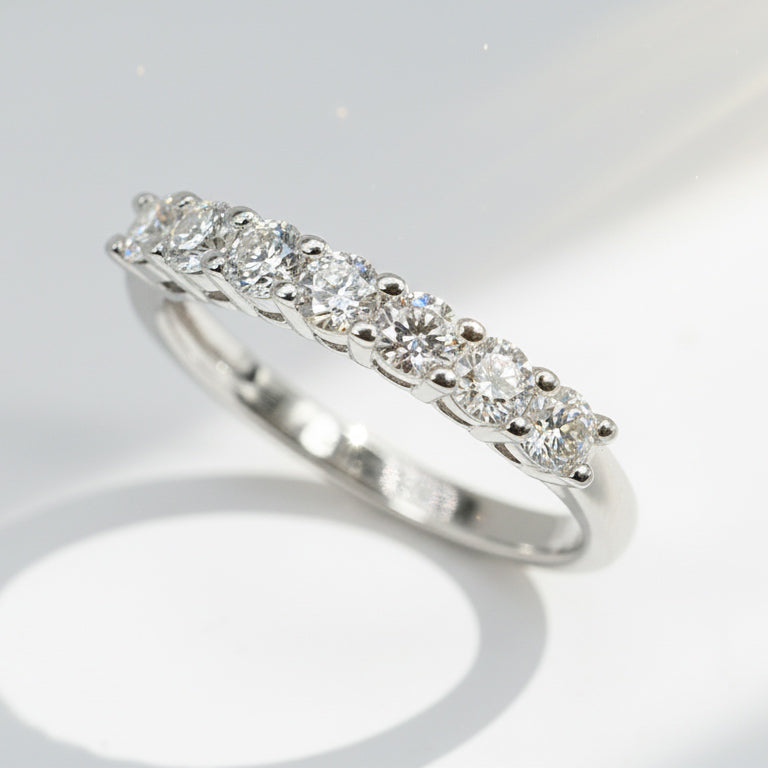 Seven-stone lab-grown diamond sterling silver band ring under natural sunlight