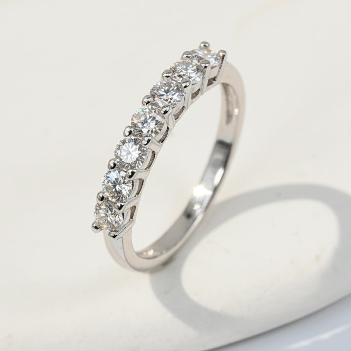 Silver ring with diamonds on a white background