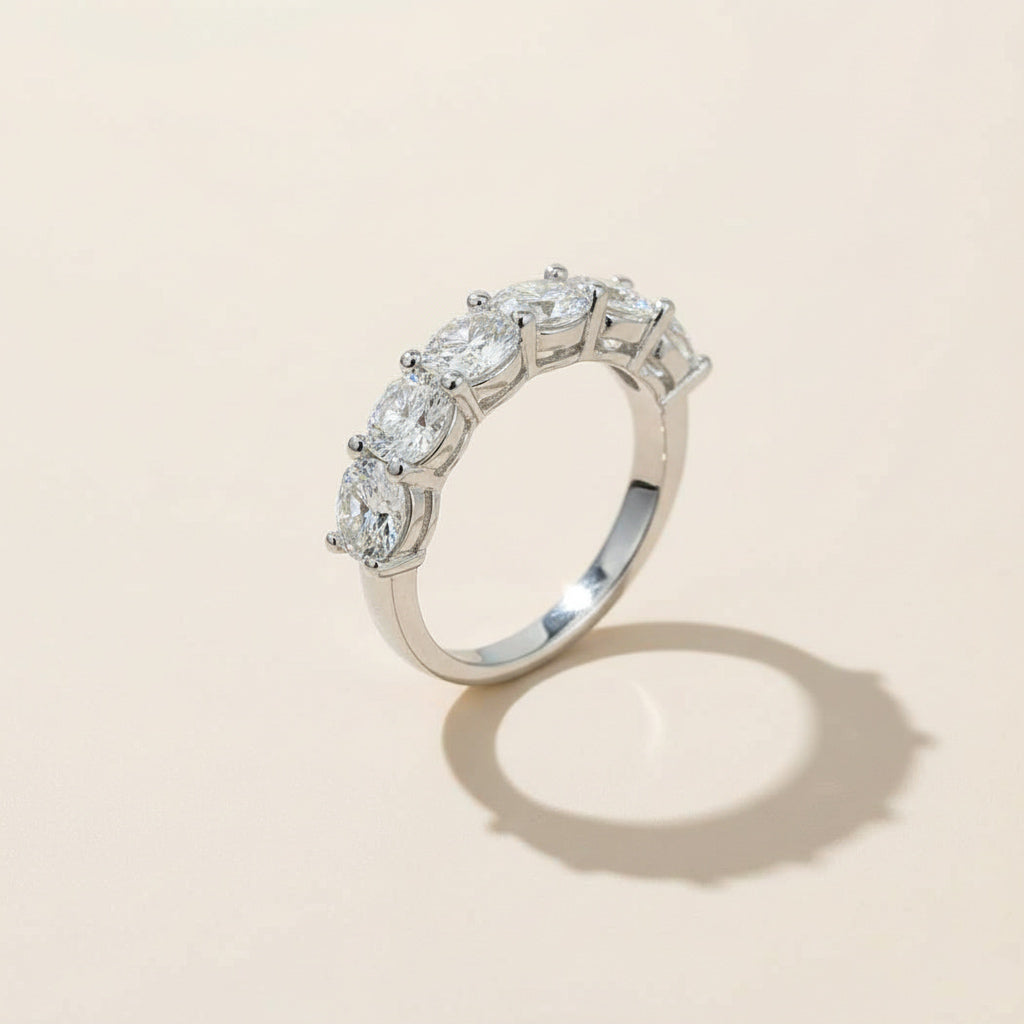 Angled view of sterling silver eternity ring with seven round-cut lab-grown diamonds