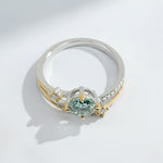Side view of green moissanite two-tone engagement ring with double-band design