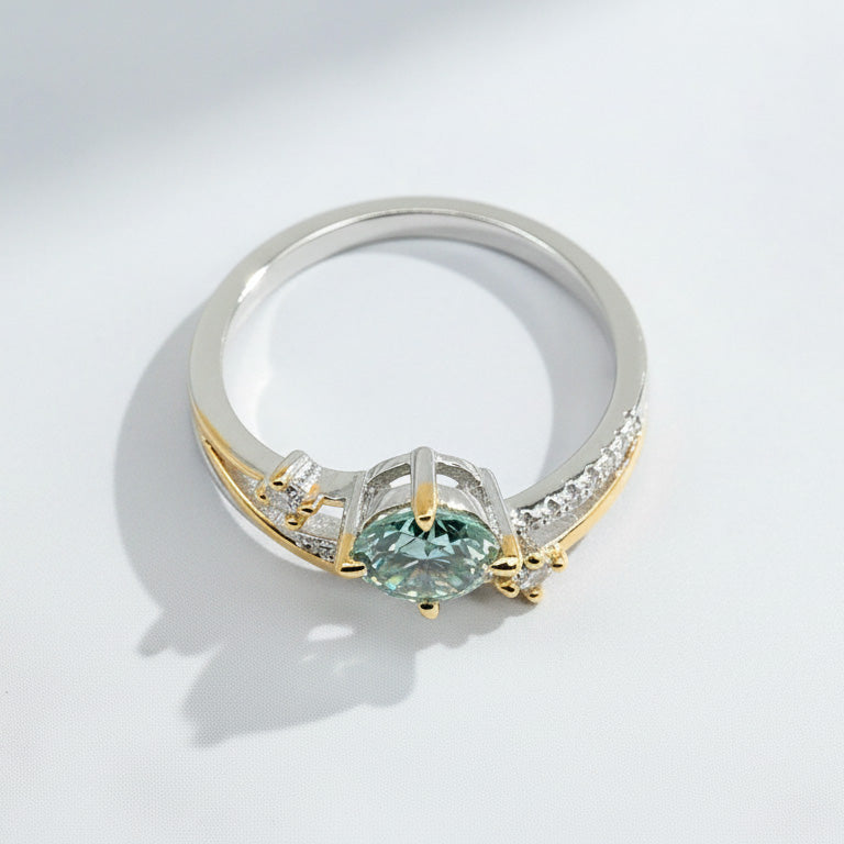 Side view of green moissanite two-tone engagement ring with double-band design