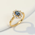 Elegant sapphire and moissanite halo ring in gold setting, vintage-inspired design