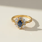 Oval blue sapphire halo ring with lab-grown diamonds in gold-plated silver band