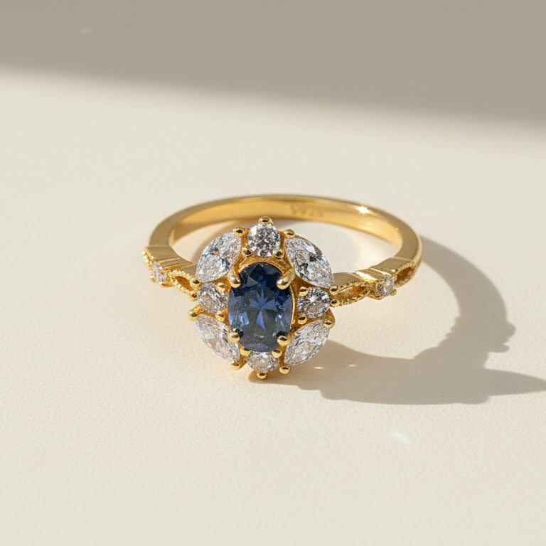 Oval blue sapphire halo ring with lab-grown diamonds in gold-plated silver band