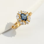 Gold vintage halo ring featuring oval sapphire and marquise-cut lab-grown diamonds