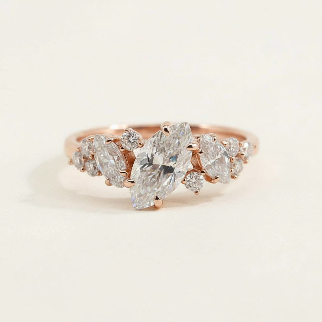 Rose gold engagement ring with marquise-cut lab-grown diamond and cluster accent stones