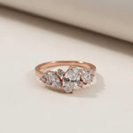 Rose gold marquise diamond ring featuring multi-stone cluster design, bridal engagement style