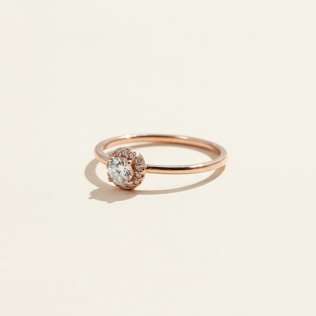 Elegant rose gold diamond ring with halo setting and brilliant cut lab-grown diamond.