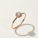 Round halo diamond engagement ring in rose gold, lab-grown center stone with pavé details.