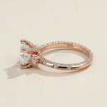 Side view of rose gold engagement ring with pavé band and moissanite stones