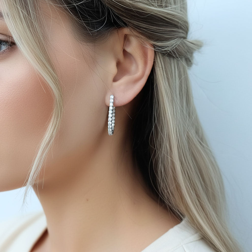 Model wearing sterling silver lab-grown diamond hoop earrings, medium size sparkle design
