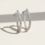 Sterling silver lab-grown diamond hoop earrings, medium size sparkle hoops on neutral background