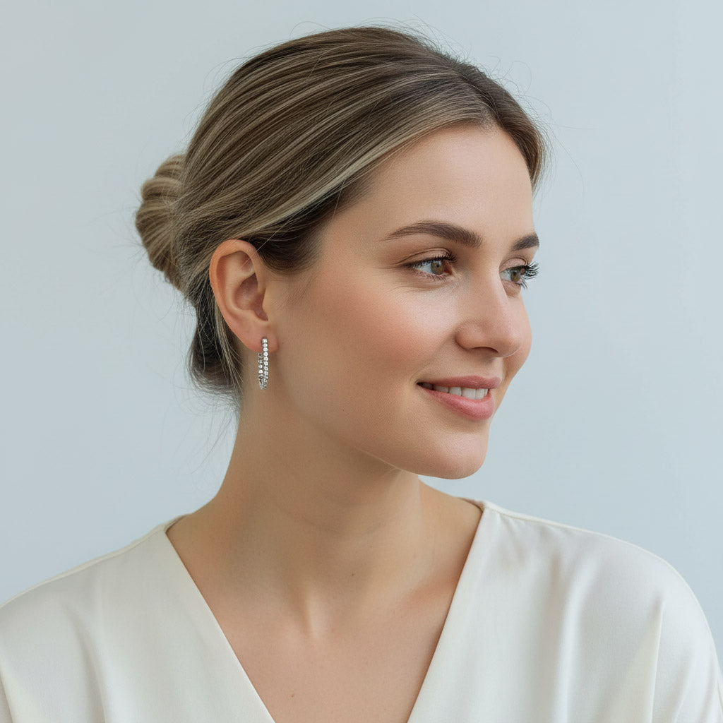 Elegant woman wearing silver diamond hoop earrings, classic everyday jewelry style