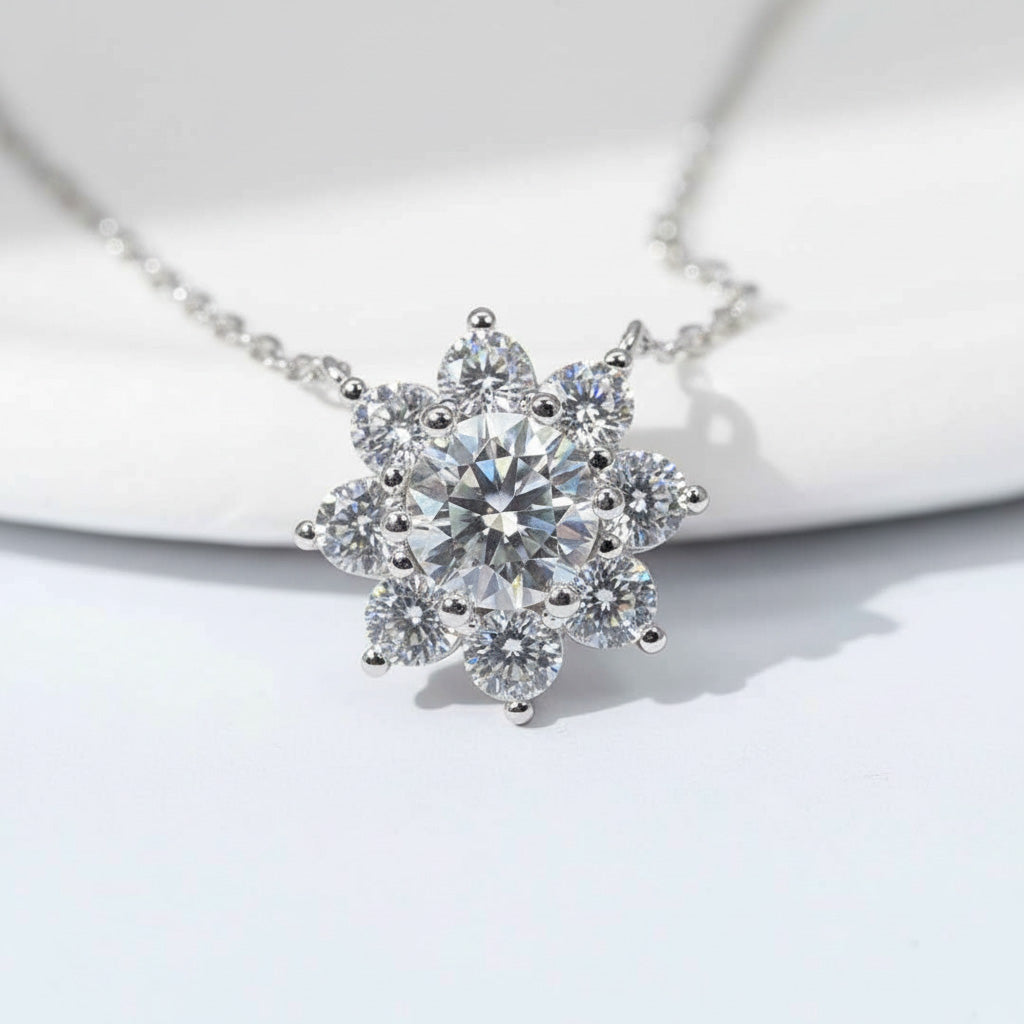Close-up of floral halo pendant with 1ct centre moissanite and halo stones on platinum plated sterling silver.