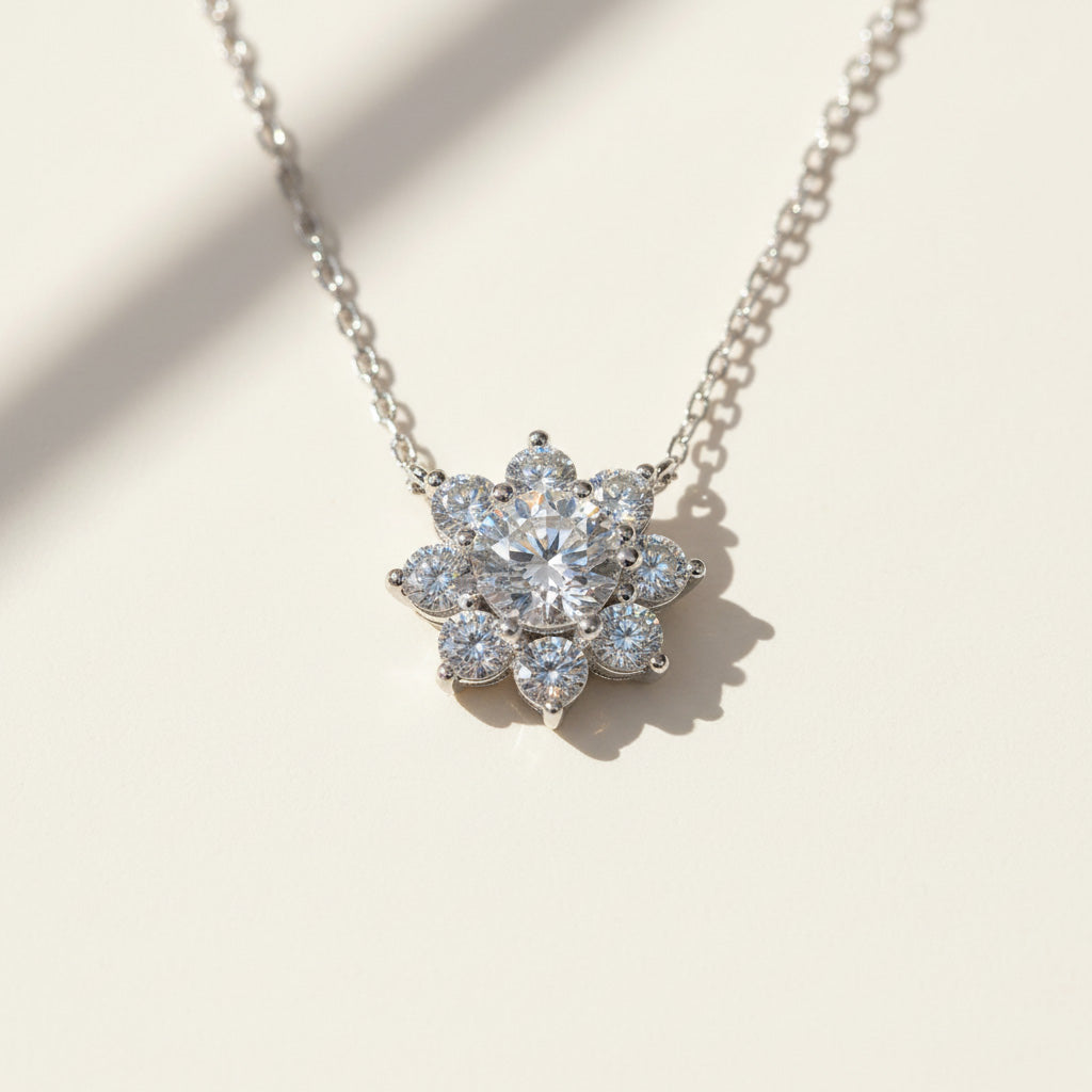 Floral halo moissanite pendant sparkling under natural sunlight, platinum plated sterling silver.