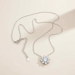 Floral halo moissanite necklace with 46cm S925 chain laid flat on light background.