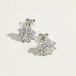 Close-up of floral moissanite earrings showing detailed halo setting.
