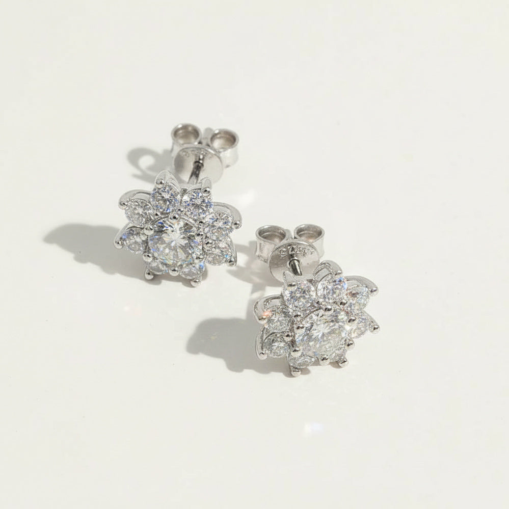 Close-up of floral moissanite earrings showing detailed halo setting.