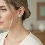 Side profile of model wearing floral moissanite stud earrings in natural light.