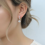 Model wearing 1ct lab grown moissanite drop earrings in platinum sterling silver
