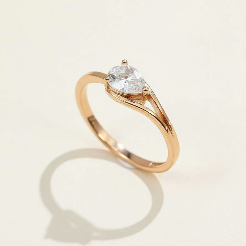 Rose gold-plated sterling silver pear-cut moissanite solitaire ring with split band, D/VVS1 1.0ct lab-grown diamond.