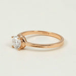 Rose gold-plated sterling silver solitaire engagement ring with round-cut moissanite D/VVS1 1.0ct stone.