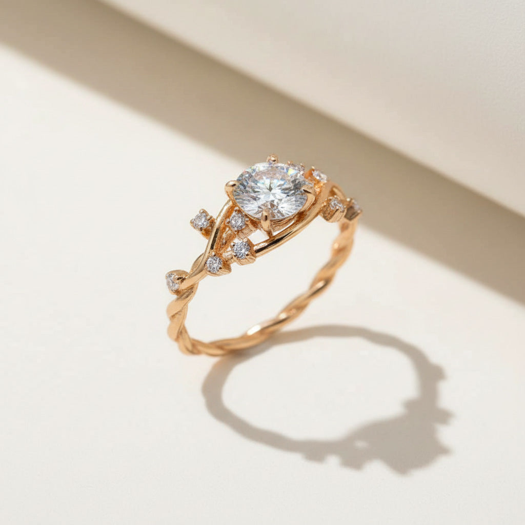 Gold-plated vine-inspired ring with round moissanite center and CZ accents on a twisted band, elegant design by A2K London.