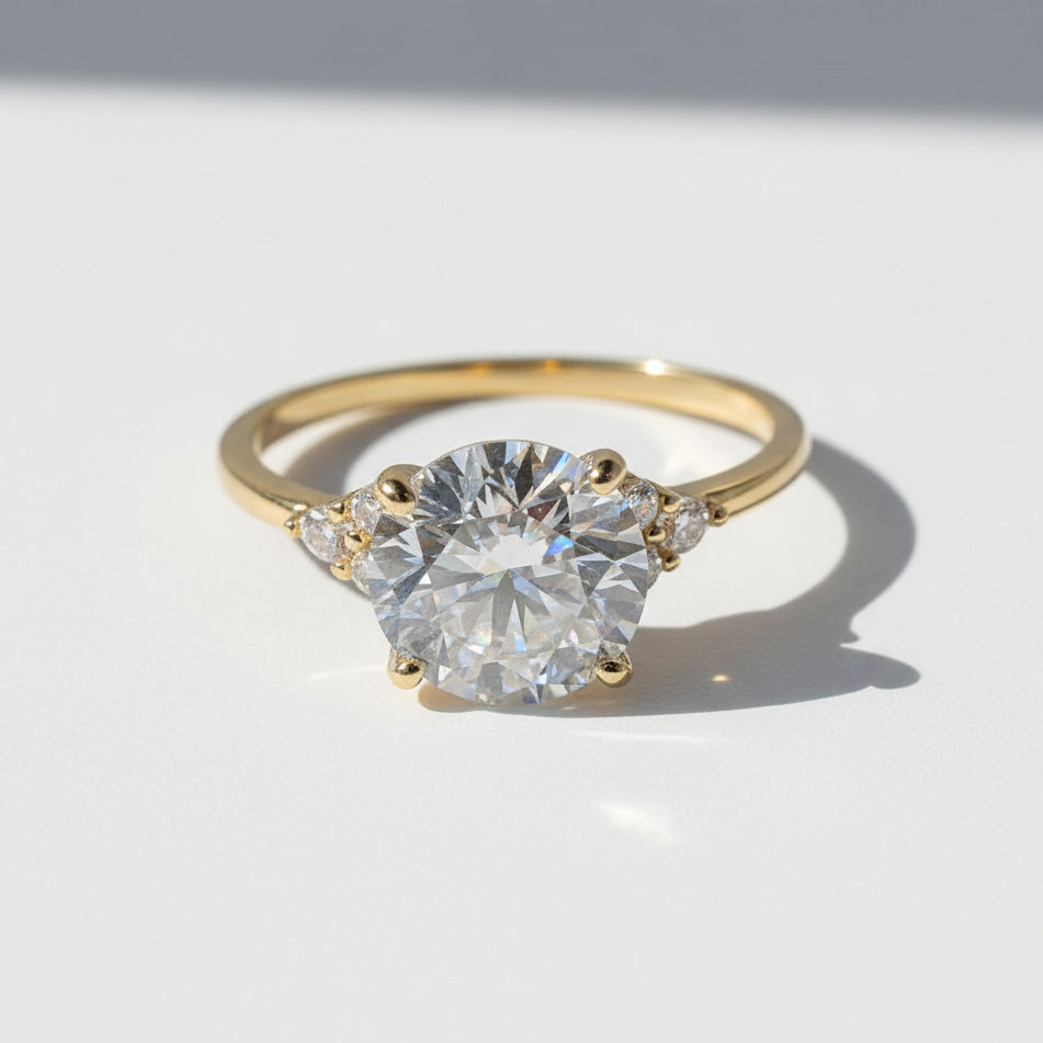 Gold 3ct round brilliant lab grown moissanite ring on white background