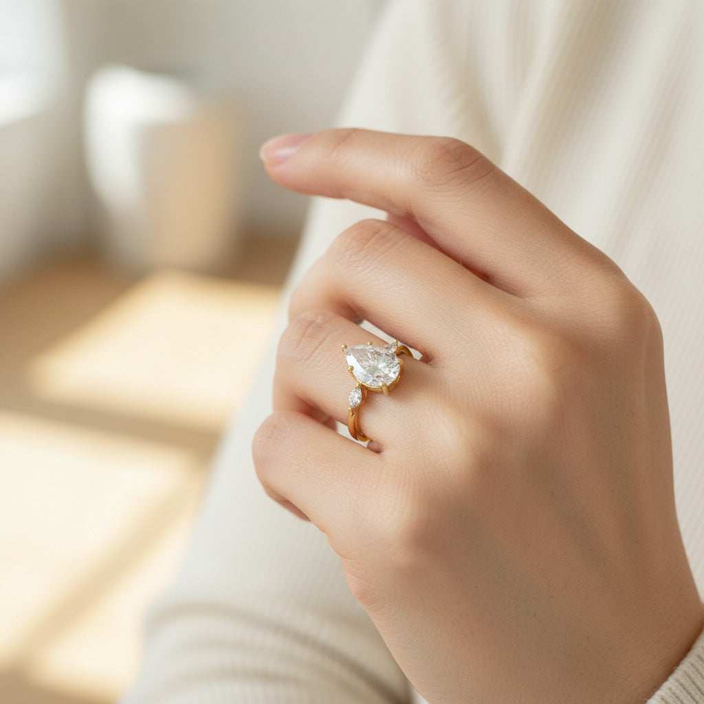 Gold 2ct D/VVS1 pear cut moissanite ring on hand