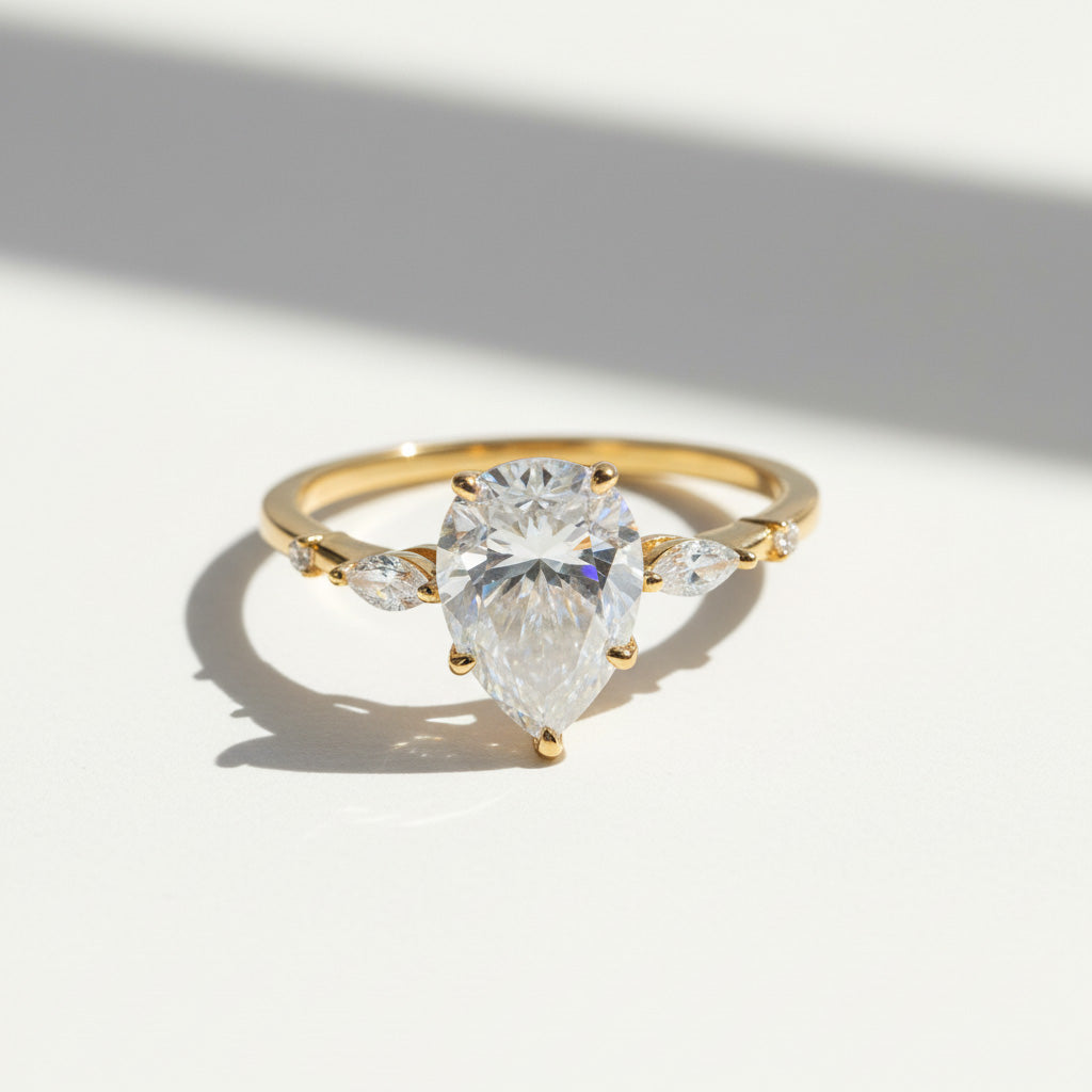 Gold pear cut D/VVS1 2ct moissanite ring close-up