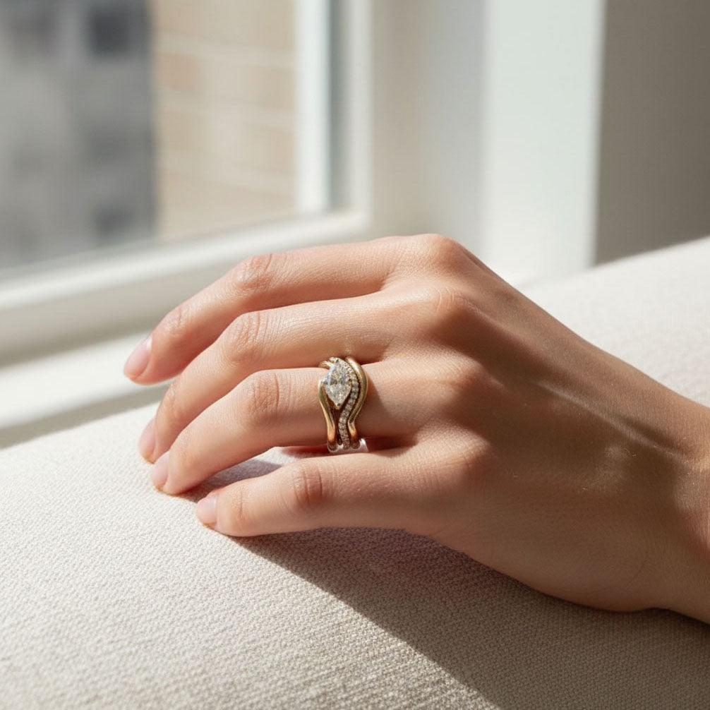 Model wearing gold-plated sterling silver marquise moissanite ring set