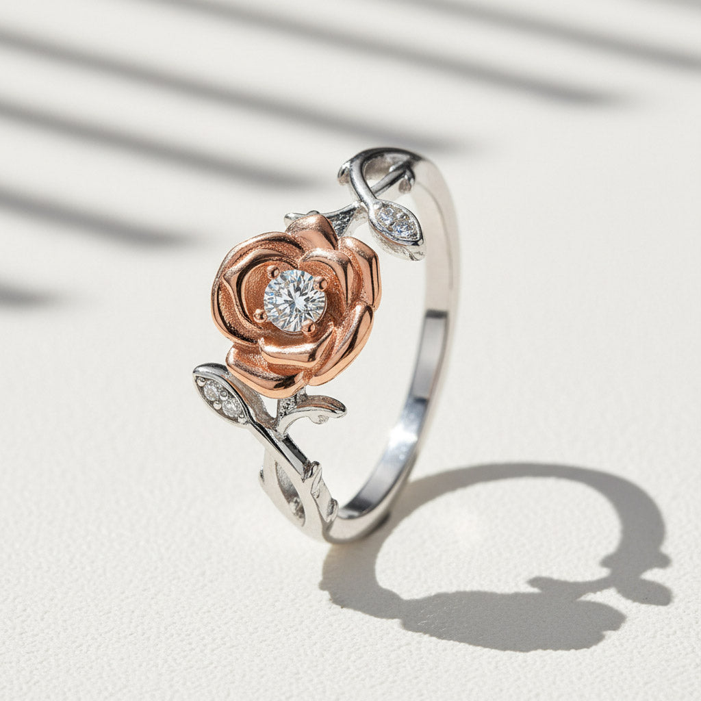 Two-tone rose flower moissanite ring with 0.1ct center stone in platinum and rose gold plated silver on a light background