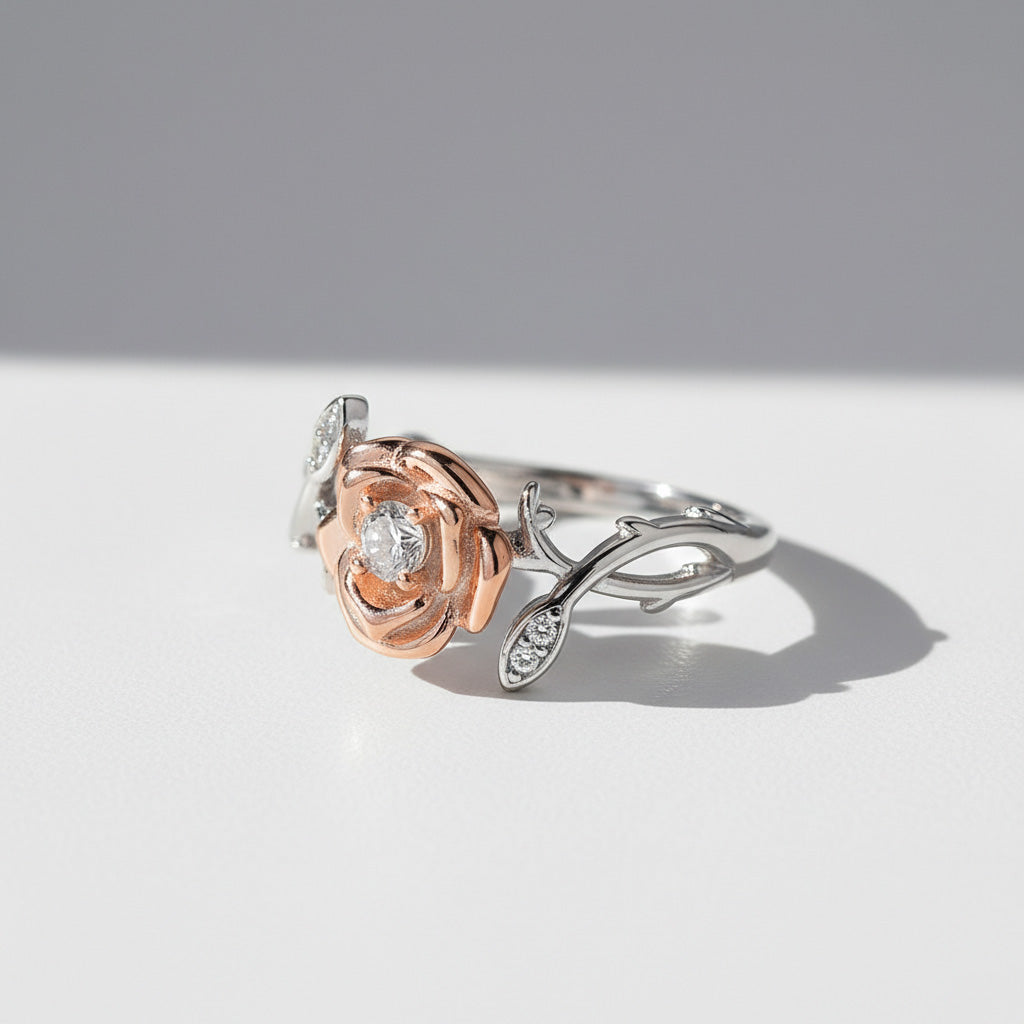 Side view of two-tone floral moissanite ring in sterling silver on a light gray background