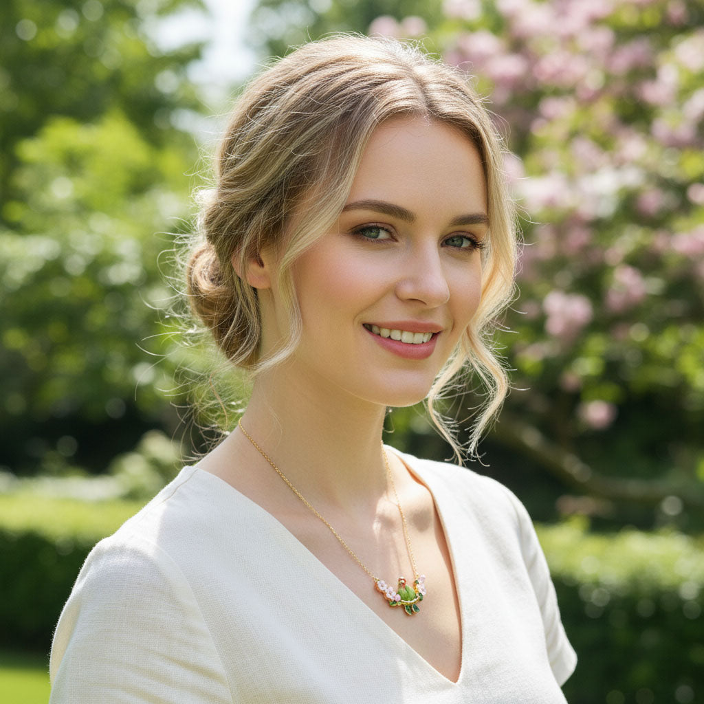Woman with a white top and necklace in a garden setting