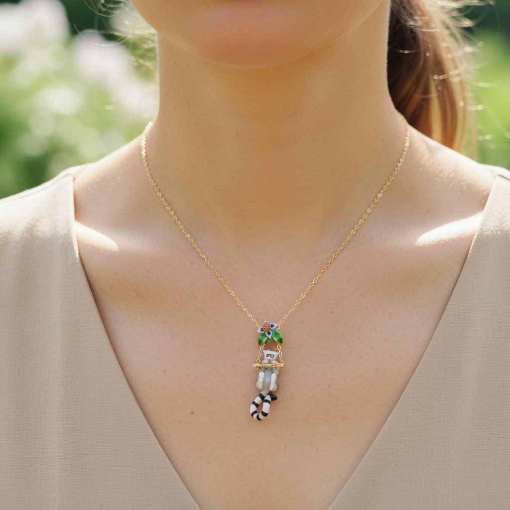 Necklace with a colorful pendant worn by a person outdoors