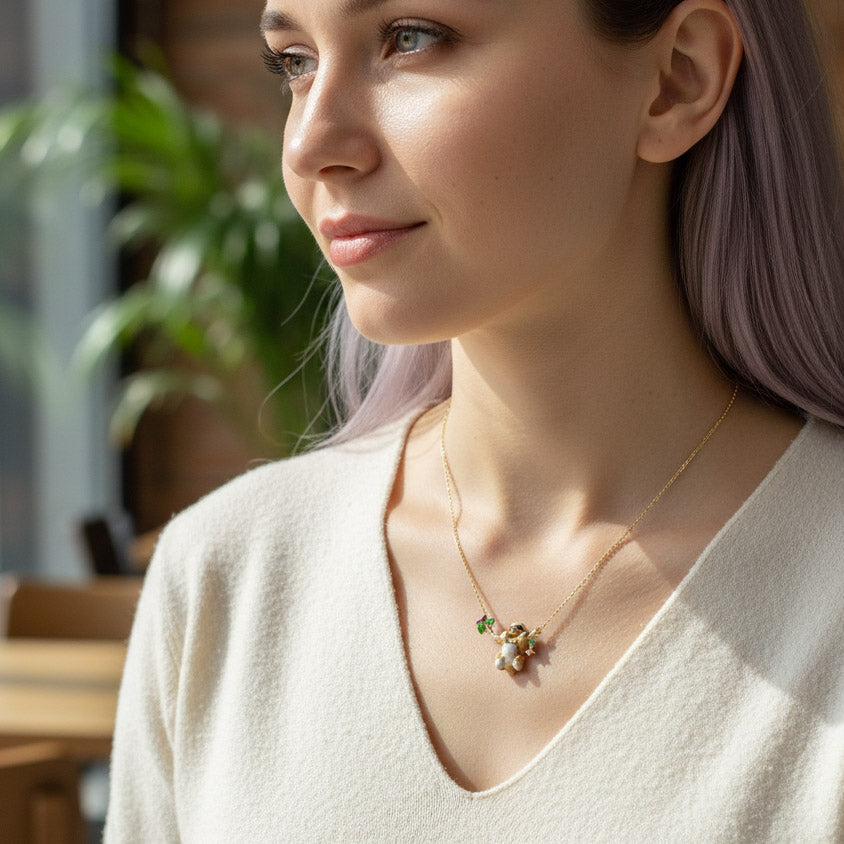 Woman wearing a delicate necklace with small pendants in an outdoor setting