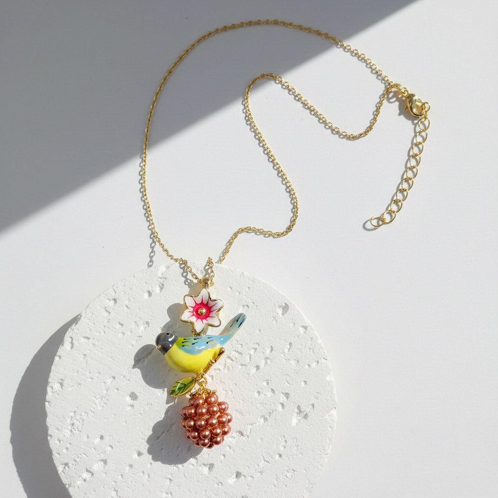 Necklace with a bird and flower pendant on a light background