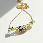 Necklace with panda design and green leaves on a white background