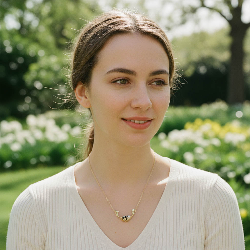 Woman wearing a necklace in a park setting with greenery and flowers.