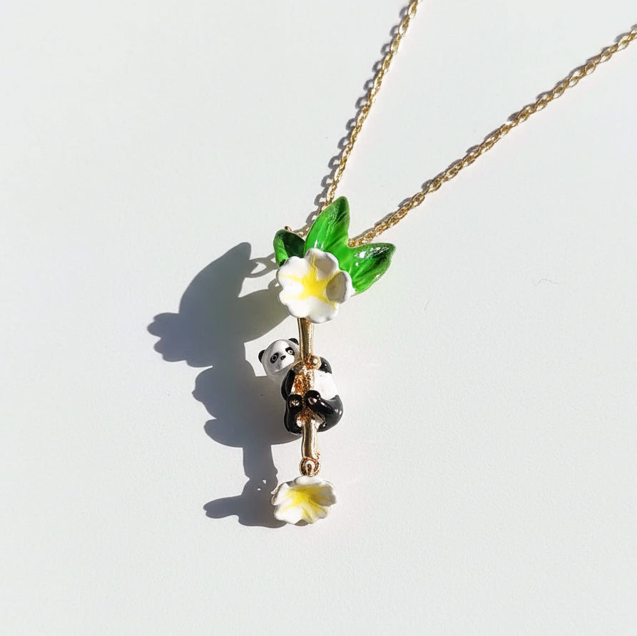 Necklace with panda and flower pendant on a white background