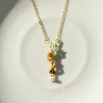 Necklace with a small animal pendant on a light gray background