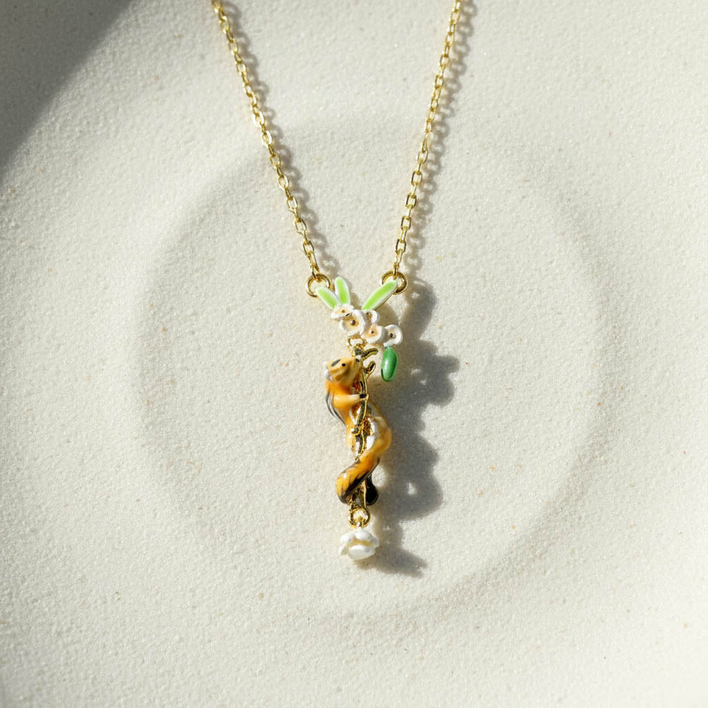 Necklace with a small animal pendant on a light gray background