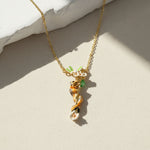 Gold necklace featuring a hand-painted chipmunk and floral vine pendant with green leaves and white flowers