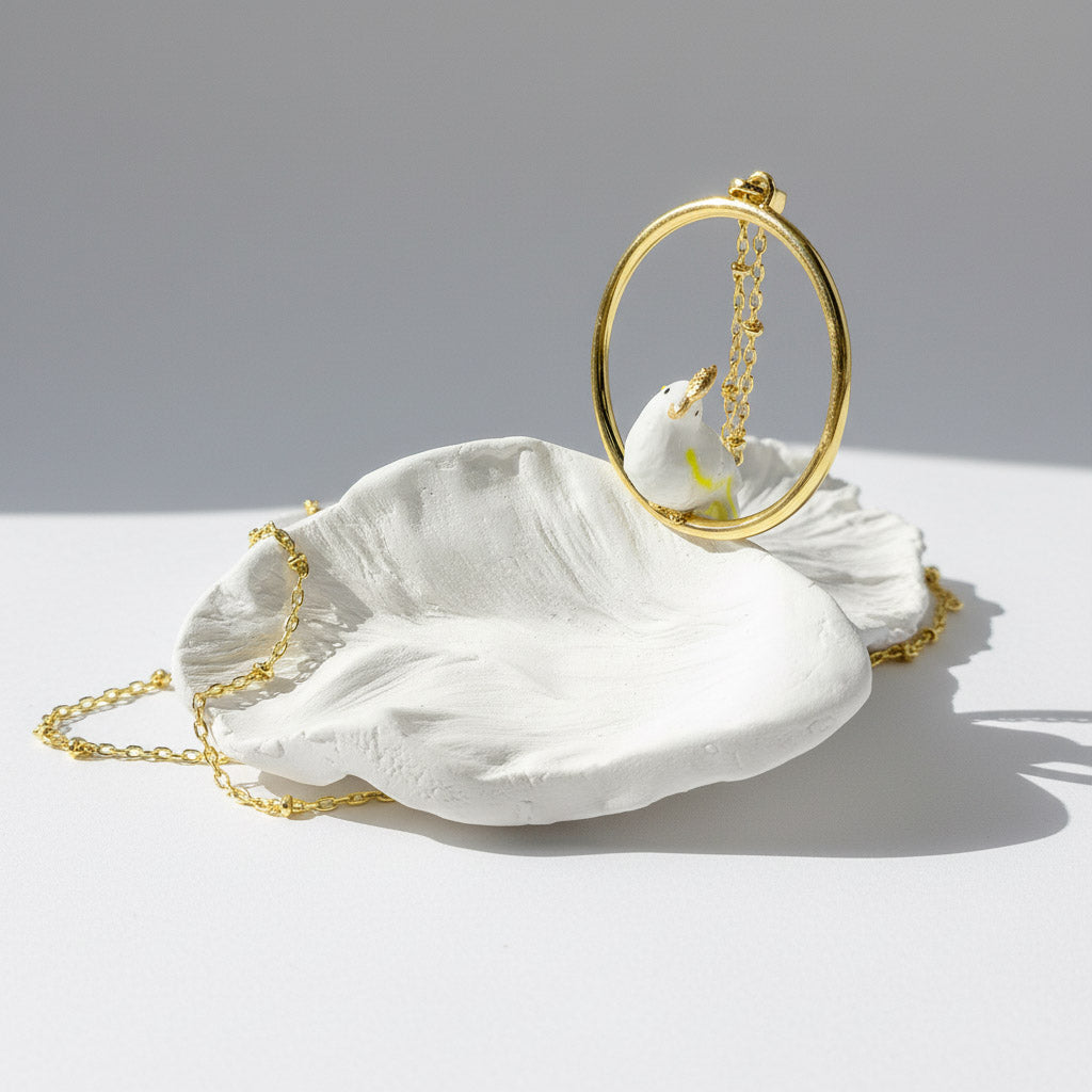 White shell with gold chain on a light gray background