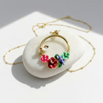 Necklace with floral pendants on a white stone surface