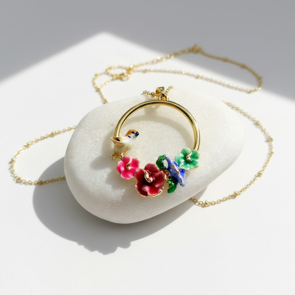 Necklace with floral pendants on a white stone surface