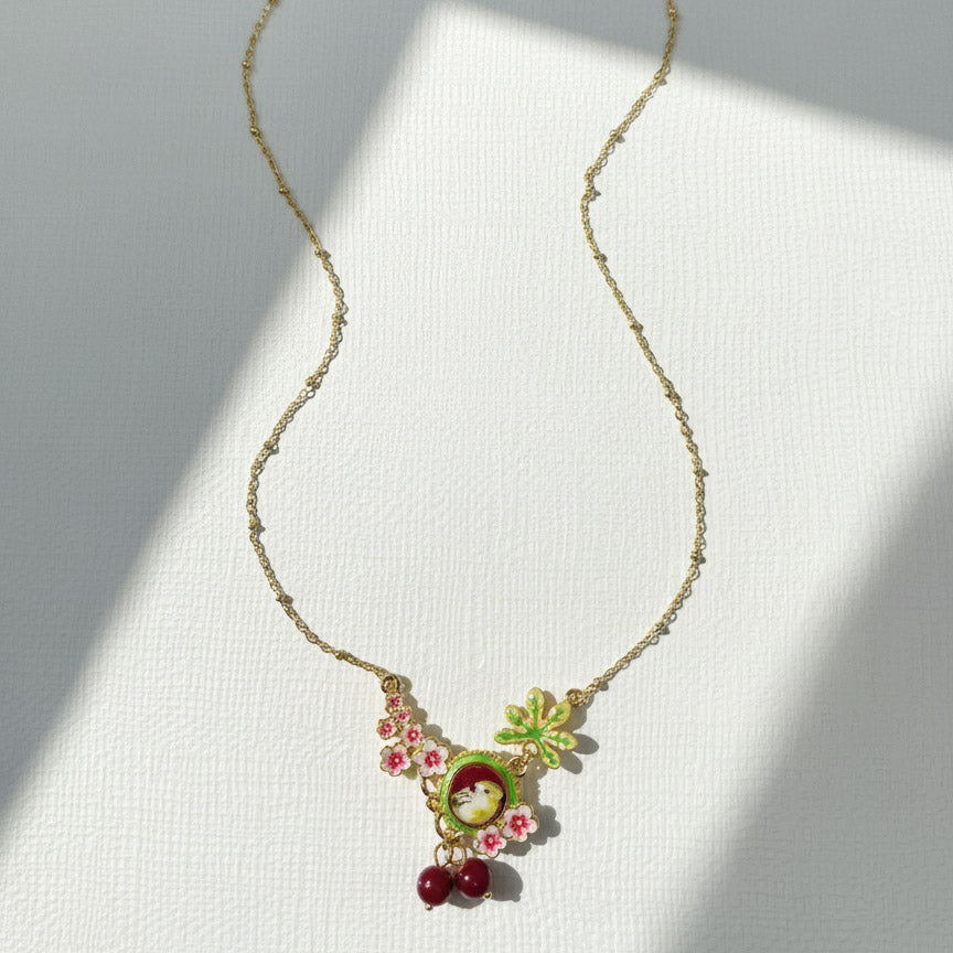 Necklace with floral and fruit pendant on a white background