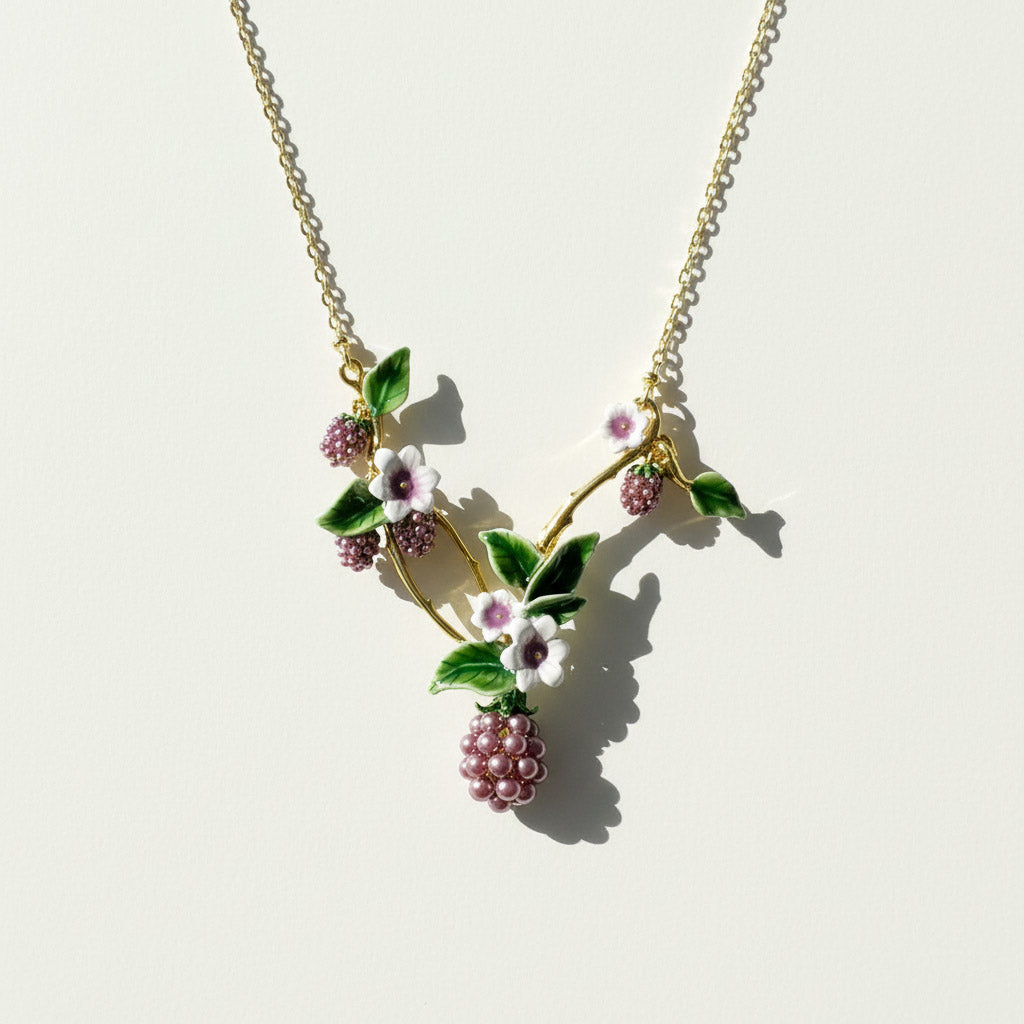 Necklace with floral and berry design on a light background