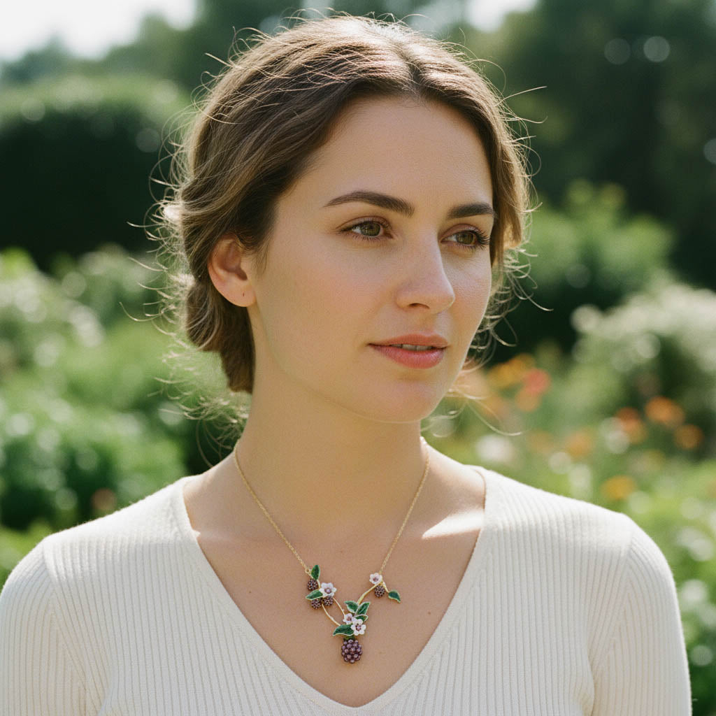 Woman wearing a necklace with a floral pendant in a garden setting
